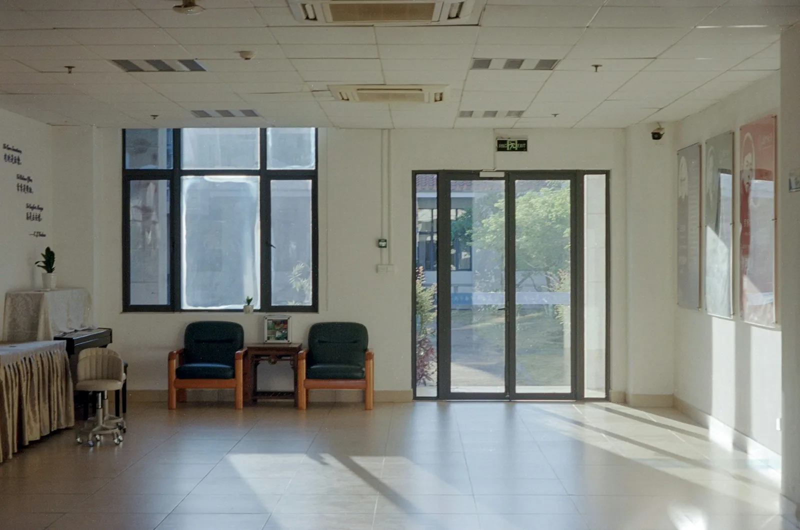 Sunlight streams into an empty waiting room with chairs